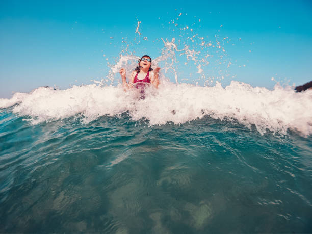istock Girl having fun on the beach 1207839270