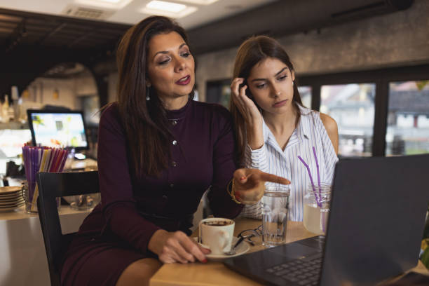 istock Mother and daughter enjoying a drink at a coffee restaurant 1207843018