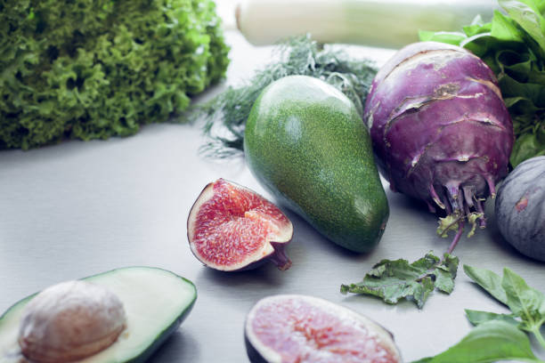 kohlrabi, figs and other green vegetables as a background