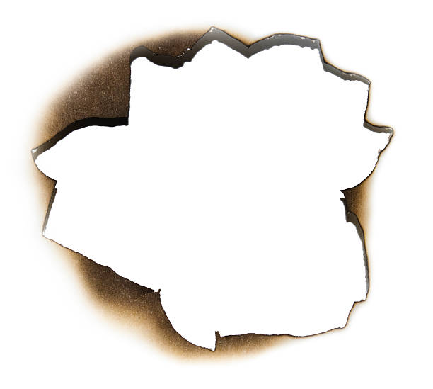 istock Burnt hole in a piece of paper 120784624