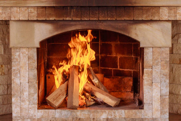 istock Burning firewood in the fireplace close up. 1207846814