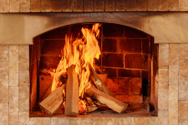 istock Burning firewood in the fireplace close up. 1207846815