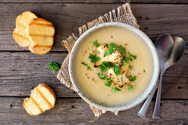 istock Roasted cauliflower and potato and soup, top view table scene over rustic wood 1207848683