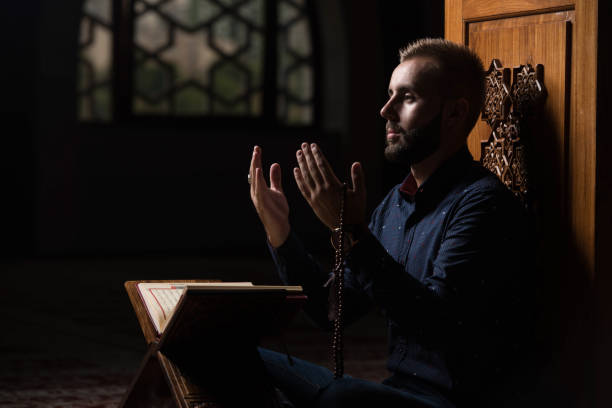 istock Young Muslim Guy Reading The Koran 1207850250