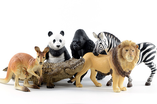 Several plastic toy animals together over a white background.