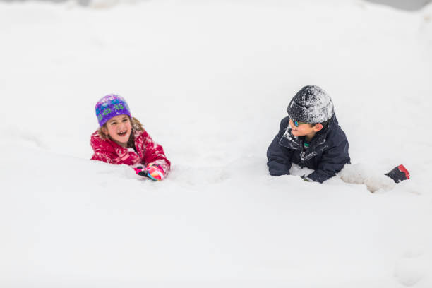 istock Kids playing and Having fun in the Snow 1207854158