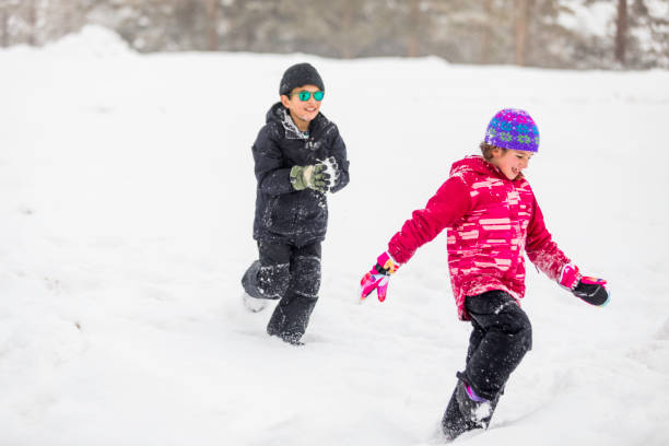 istock Kids playing and Having fun in the Snow 1207854160