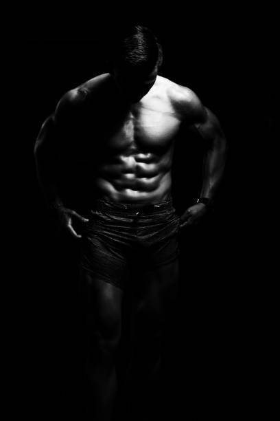istock Muscular Man Flexing Muscles In Gym 1207854290