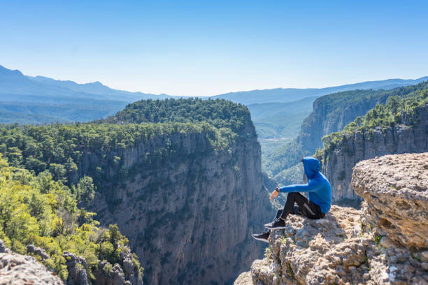istock Greyhound Canyon. An athlete sitting against the landscape 1207855032