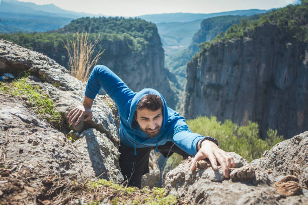 an athlete climbing the mountain