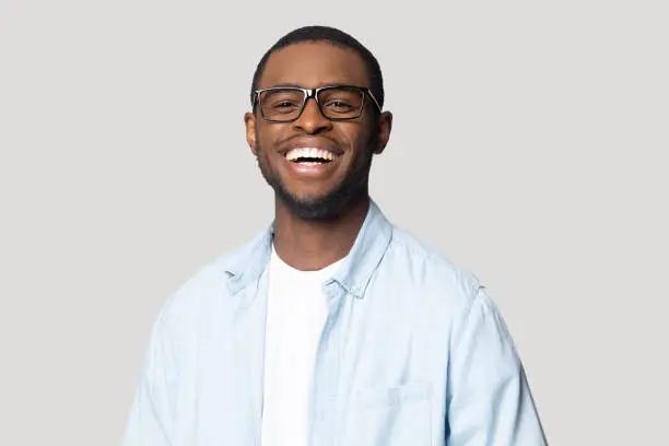 Photo of Joyful happy african american young man in eyeglasses portrait.