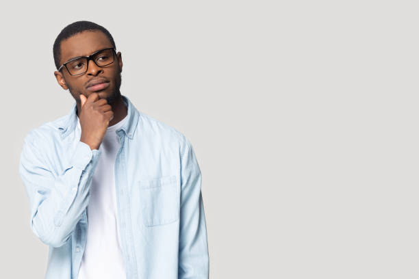 istock Thoughtful young african american guy looking at blank copy space. 1207856391