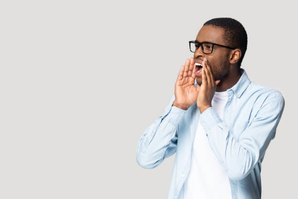 istock Emotional african american millennial guy shouting at copyspace. 1207856396