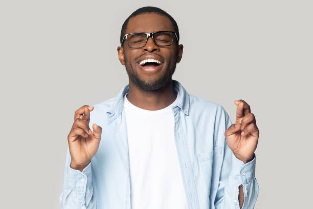 istock Superstitious happy african american young man wishing good luck. 1207856412