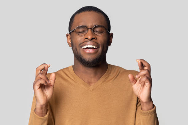 istock Hopeful superstitious millennial african american guy wishing good luck. 1207856420