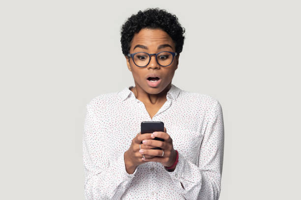 istock Astonished young african american woman received unexpected news. 1207856474
