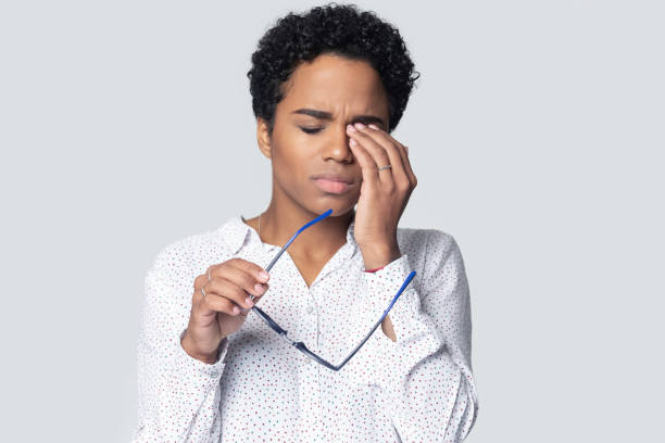 istock Exhausted millennial ethnic woman rubbing irritated eyes. 1207856513