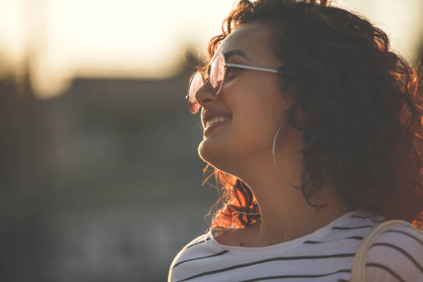 istock Portrait of a smiling curly haired brunette 1207856559