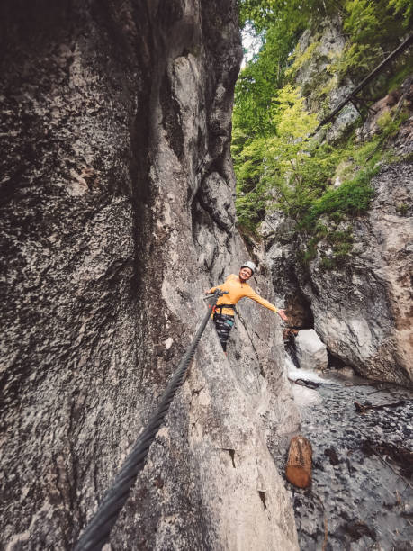 istock Happy hiker climbing via ferrata 1207856693