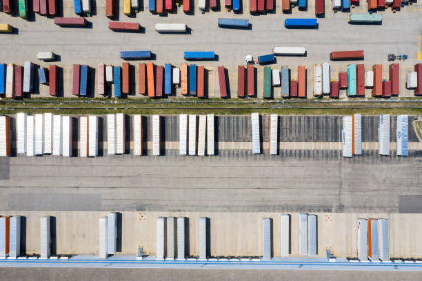 istock Aerial View of Trucks During Unloading in Front of Warehouse 1207857990