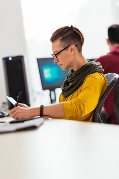 istock Businesswoman working in the office and writing notes 1207859038