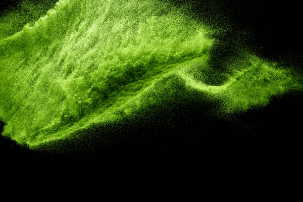 istock Green dust particles explosion on black background. Powder dust splash. 1207872184