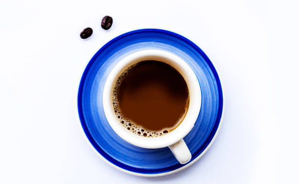 istock Blue coffee cup and coffee beans on a gray background - Top view 1207879751