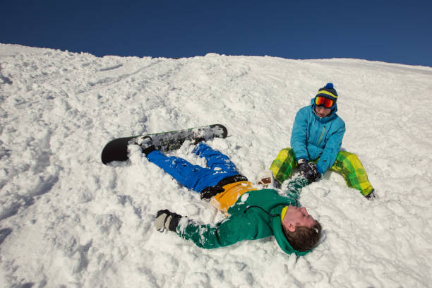 istock Snowboarder falling down Injured arm and get First aid in snow mountain 1207879829