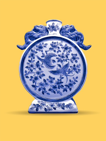 ancient old traditional blue chinese vase jar isolated on clean yellow background with clipping path