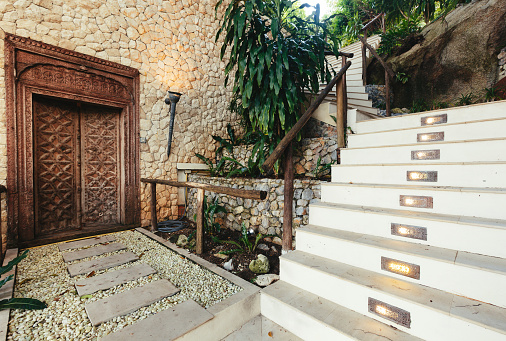 Staircase  steps and old stile wooden door in tropical  luxury villa
