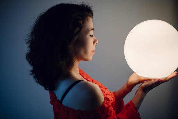 istock Young woman mixed race keep glowing ball lamp 1207883291