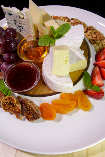 istock Camembert cheese, Parmesan, blue cheese.Cheese plate. 1207883328