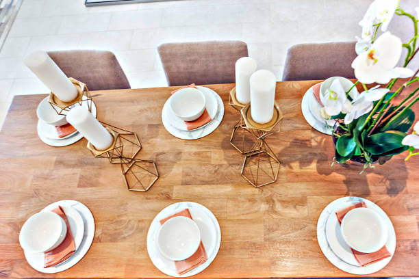 istock Modern dining table set up with dishes and fancy plant 1207883361