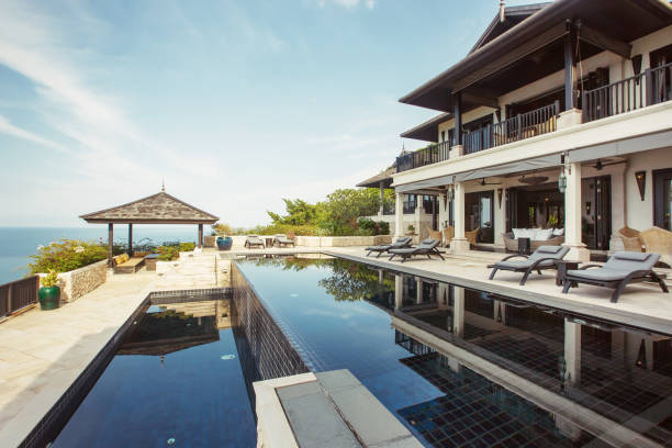 istock Swimming pool with sea view in luxury villa interior 1207884314