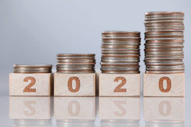 istock Set of silver coins standing at wooden bricks in growing order 1207887065