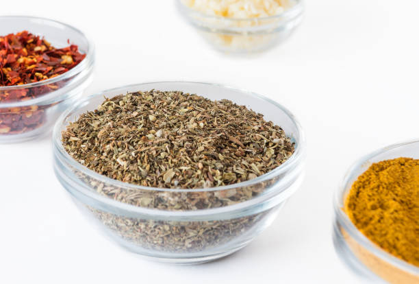 istock various spices in glass bowls on white background. Culinary Concept with curry, Italian herb mix, crushed pepper and garlic 1207887239