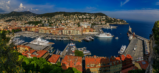 Nice, France - May 25, 2019: View of boats, coastline and traditional houses in Lympia port on the Mediterranean Sea, Cote d'Azur in Nice, France