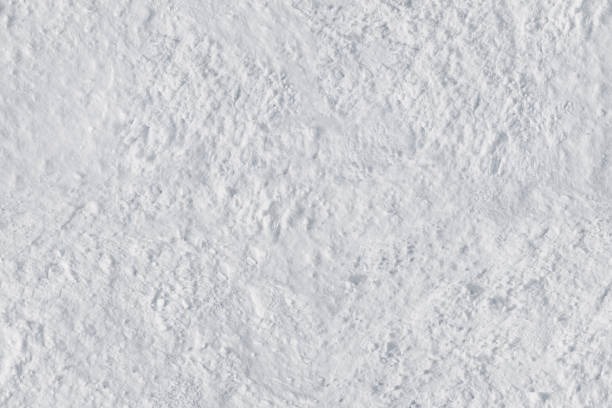 istock White snow close-up with a textured rough surface .Texture or background 1207889228