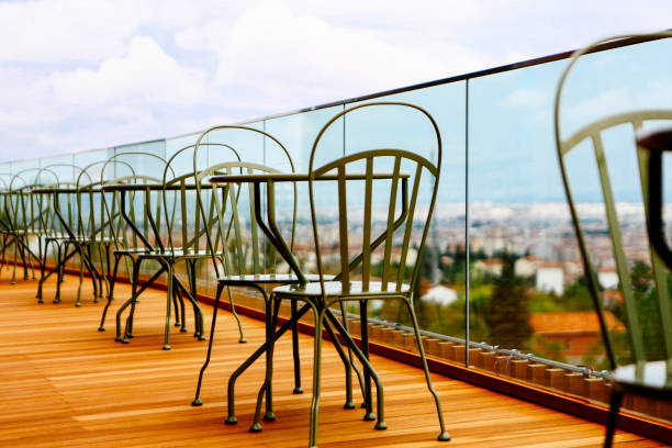 Empty tables chairs in front of the landscape, metal design.