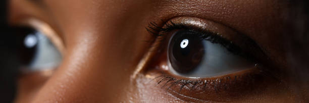 istock Black woman wide opened left eye 1207890979