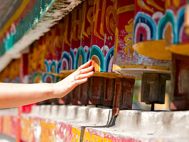 Female hand spinning the prayer wheels for good karma