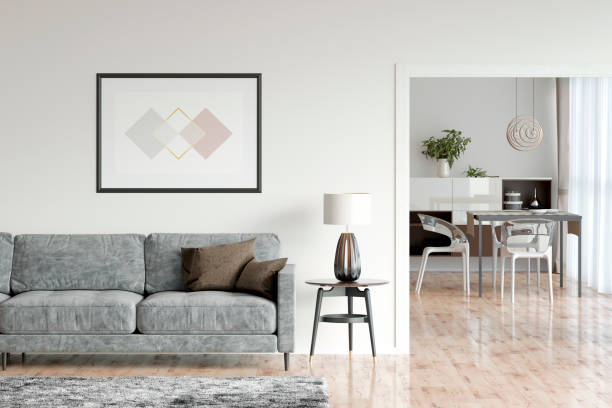 Bright living room interior with parquet floor, shaggy carpet, horizontal poster, the reading lamp next to a cozy gray sofa, overlooking the dining room. Front view. 3d render domestic room stock pictures, royalty-free photos & images