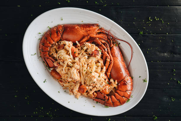 istock Pasta with Lobster meat on the black background 1207893959