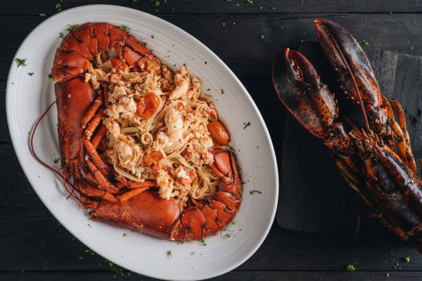 istock Pasta with Lobster meat on the black background 1207893972