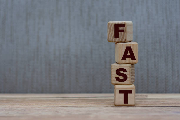 istock concept word fast on vertical cubes on a gray background 1207894182