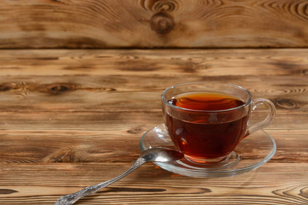 istock A glass cup of tea on a wooden table. 1207894382