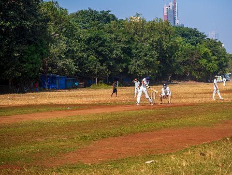 Mumbai, India - December 18, 2019: Indias most famous sport Cricket practiced by kids at local Mumbai ground
