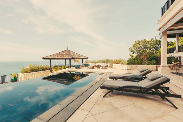 istock Swimming pool with sea view in luxury villa interior 1207902150