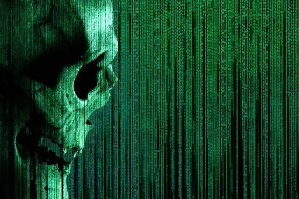 Photo of Human skull on green binary code matrix background. Side view of a human skull. Concept: hacker and computer virus, database theft, spam.