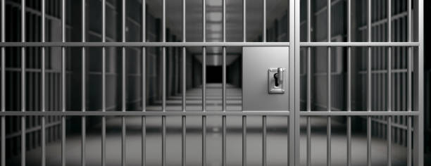 istock Prison interior. Jail cells and shadows, dark background. 3d illustration 1207905643